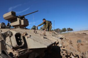 ARMISTICE EXPIRING An Israeli soldier climbs aboard an armed APC (armored personnel carrier) in southern Israel near the border with the Gaza Strip on Thursday, Nov. 30, 2023, as a truce between Israel and Hamas enters its seventh day. A truce between Israel and Hamas was extended on November 30 just before it was due to expire, the two sides announced, with mediator Qatar reporting it would continue for one day under the same conditions that saw hostages released in exchange for prisoners. AFP PHOTO