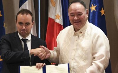 France's Minister for the Armed Forces Sebastien Lecornu (L) shakes hands with Secretary of National Defense of Philippines Gilbert Teodoro after signing documents at a hotel in Manila on December 2, 2023. AFP PHOTO