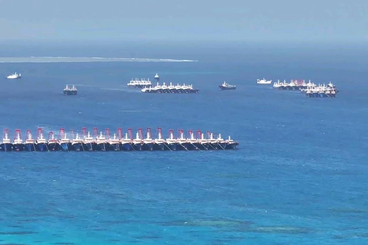 This aerial photo shows part of the Subi Reef and Chinese vessels identified by the Philippines as ‘maritime militia’ near Thitu Island in the disputed South China Sea on Friday, Dec. 1, 2023. AFP PHOTO