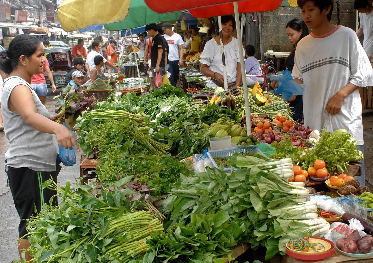A woman buys vegetable at a market in Manila, 07 August 2007.  Philippine consumer prices rose at a higher than expected clip of 2.6 percent in July, the government announced 07 August 2007, as a dry spell pushed up food and utility costs with the July figure at 0.3 percentage points above the June number.   AFP PHOTO/Jay DIRECTO
pt2 / august 8 / 070807_economy03.jpg