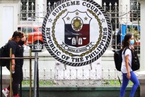 270422_SUPREMECOURT-ALQUINTO People walk past the logo of Philippine Supreme Court along Padre Faura Avenue in Manila, on 27 April 2022. PHOTO BY MIKE ALQUINTO