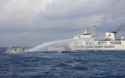 This handout photo taken and released on Dec. 10, 2023, by the Philippine Coast Guard (PCG) shows a China Coast Guard vessel (right) using water cannon against the M/L Kalayaan chartered supply boat during a mission to deliver provisions at Second Thomas Shoal in disputed waters of the South China Sea (SCS). A Philippine boat was 'rammed' by a Chinese coast guard ship during a resupply mission on Sunday, the PCG said, in the latest such confrontation in the disputed SCS. AFP