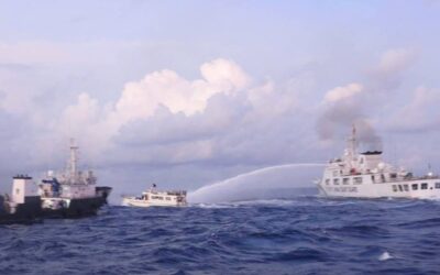 This handout photo taken and released on December 10, 2023 by the Philippine Coast Guard (PCG) shows a China Coast Guard vessel (right) using water cannon against the M/L Kalayaan chartered supply boat (center) during a mission to deliver provisions at Ayungin Shoal in disputed waters of the South China Sea. AFP PHOTO /  PHILIPPINE COAST GUARD