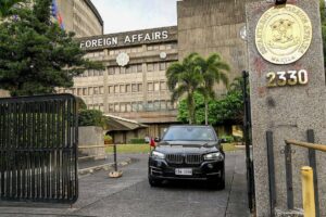 A Chinese diplomatic vehicle leaves the Department of Foreign Affairs in Manila on December 11, 2023. The Philippines said it had summoned China's envoy on December 11 and flagged the possibility of expelling him following the most tense confrontations between the countries' vessels in years at flashpoint reefs in the disputed South China Sea. JAM STA ROSA / AFP