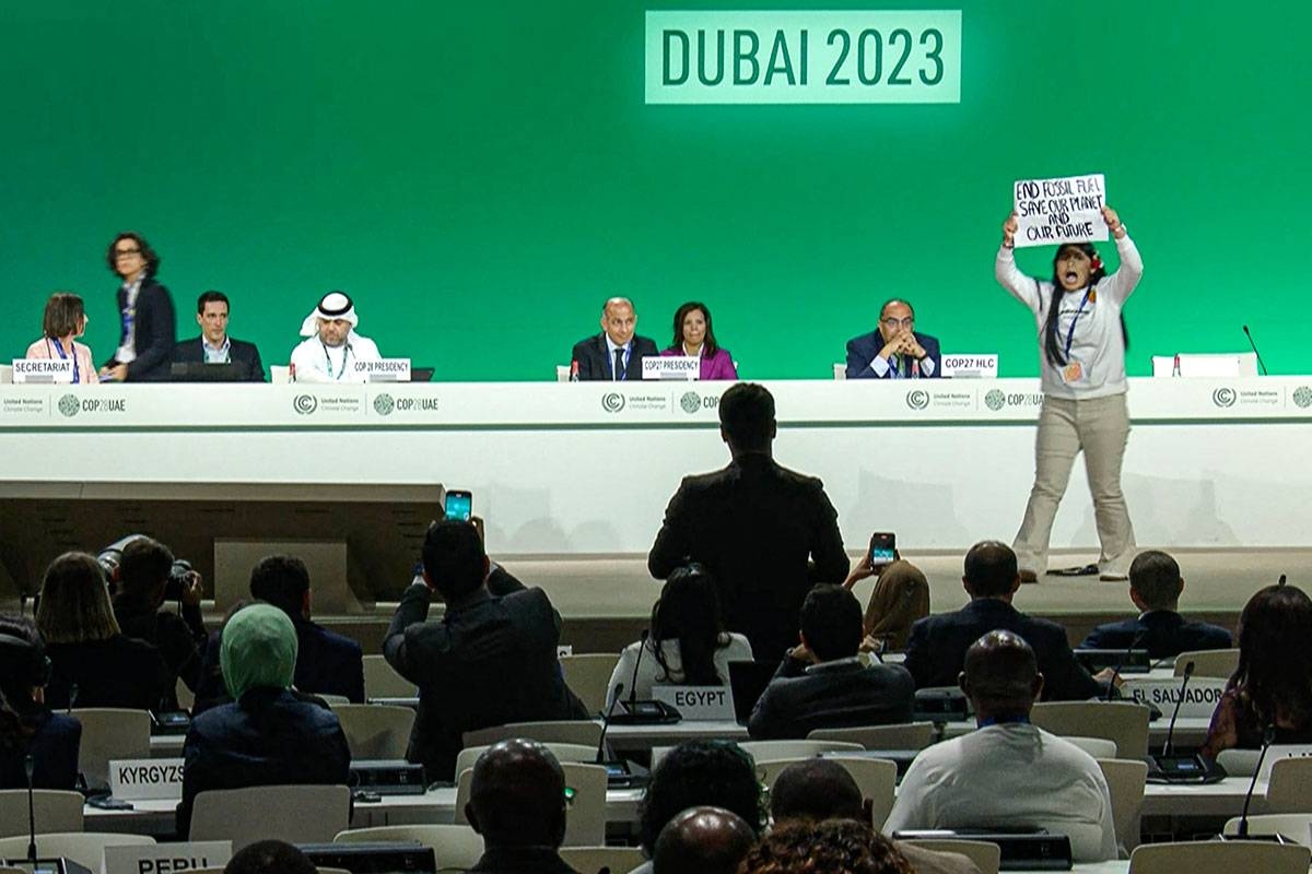 This image grab taken from AFPTV video footage shows an activist protesting on stage against fossil fuels during an event at the United Nations Climate Conference in Dubai on December 11, 2023. AFP