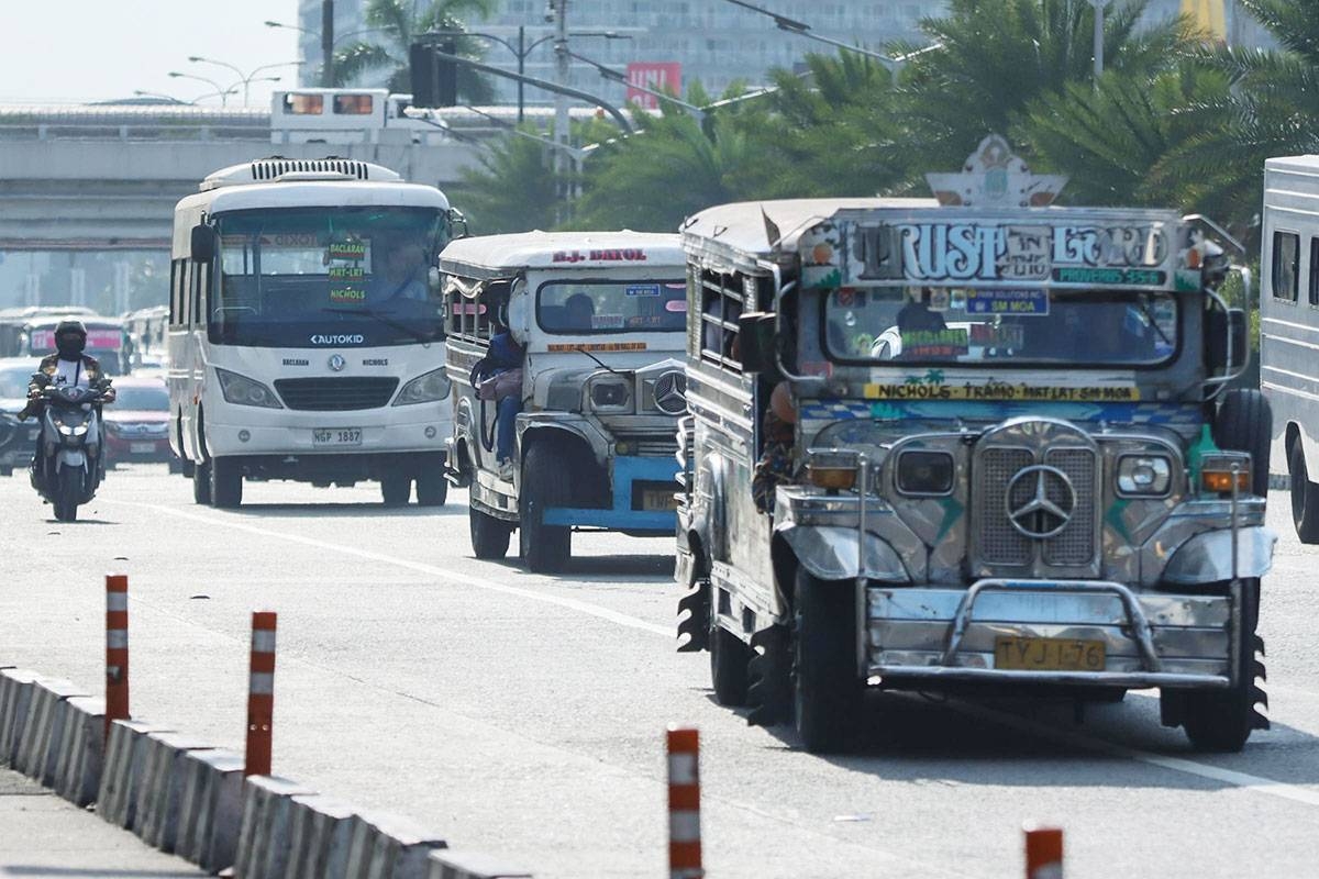 Air-conditioned mini-buses, considered by many as the modern jeepneys, are seen along EDSA, Sunday afternoon alongside traditional jeepneys. PHOTO BY J. GERARD SEGUIA
