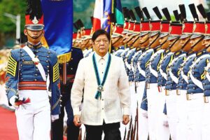 TROOPING THE LINE President Ferdinand Marcos Jr. (right), as commander-in-chief, walks past the honor guards during the AFP’s 88th Anniversary celebration at Camp Aguinaldo in Quezon City on Thursday, Dec. 21, 2023. PHOTO BY MIKE ALQUINTO