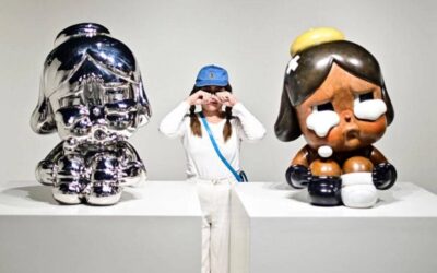 A visitor poses for photographs next to art sculptures, part of an exhibition titled "Everybody Cries Sometimes" by Thai artist Molly in Bangkok AFP FILE PHOTO