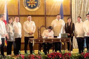 SIGNED President Ferdinand Marcos Jr. signs into law the national budget for 2024. CONTRIBUTED PHOTO