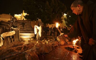 SOMBER CELEBRATION A priest places a candle in front of a nativity scene installed with rubble — in reference to the war in Gaza — in front of the Church of the Nativity in the city of Bethlehem in the occupied West Bank on Saturday, Dec. 23, 2023. AFP PHOTO