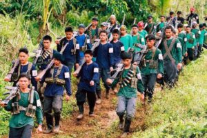 Heavily armed communist guerrillas of the New People's Army (NPA) parade in a village in Lianga town in the rebel's mountain stronghold in southern Mindanao island 06 January 2004. Communist guerrilla leaders earlier announced that they will charge politicians "permit to campaign" fees in areas where the NPA are active. The militlary said the rebels charge about a million pesos (18,080 USD) for each senatorial candidate with smaller sum s for local candidates during the 2001 elections.  AFP PHOTO    STR
File:080104_npa01
Photos today3/news/1-09