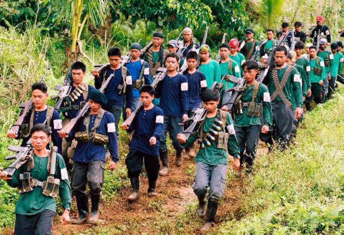 Heavily armed communist guerrillas of the New People's Army (NPA) parade in a village in Lianga town in the rebel's mountain stronghold in southern Mindanao island 06 January 2004. Communist guerrilla leaders earlier announced that they will charge politicians "permit to campaign" fees in areas where the NPA are active. The militlary said the rebels charge about a million pesos (18,080 USD) for each senatorial candidate with smaller sum s for local candidates during the 2001 elections.  AFP PHOTO    STR
File:080104_npa01
Photos today3/news/1-09
