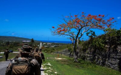 File photo shows US Marines and sailors hiking through the island of Tinian. AFP