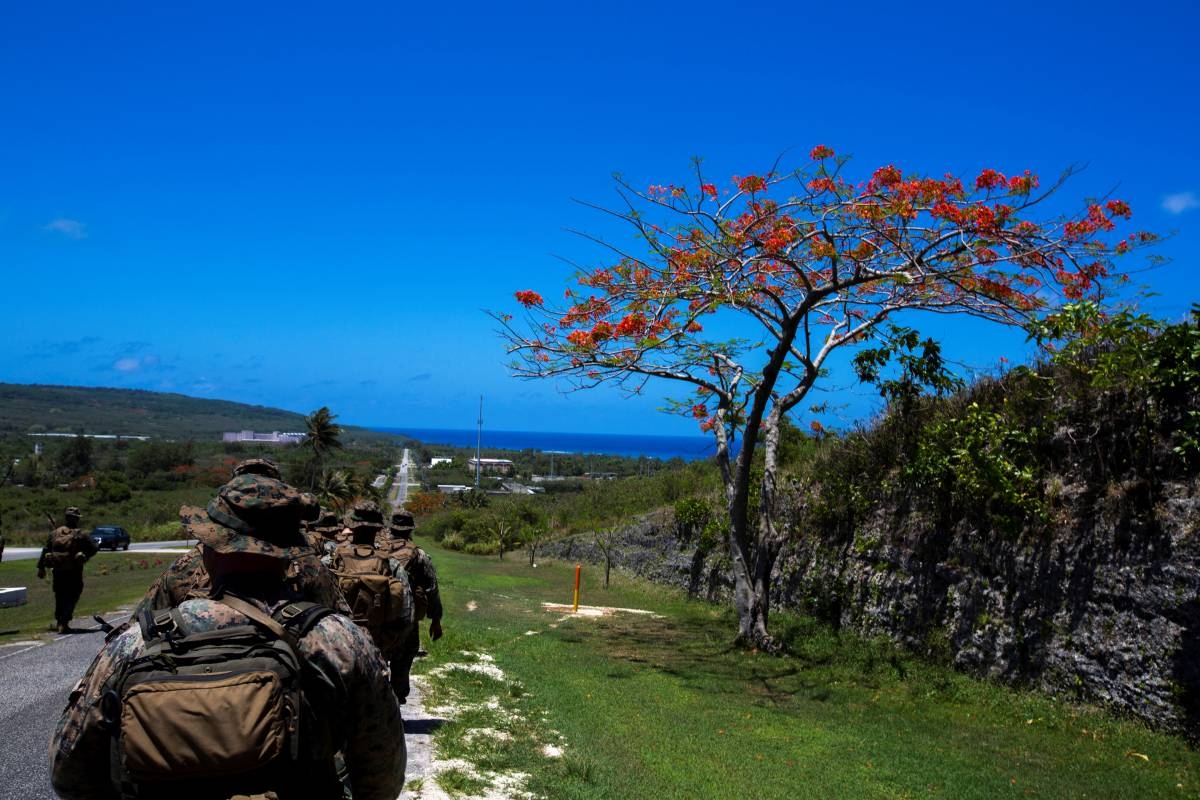 File photo shows US Marines and sailors hiking through the island of Tinian. AFP