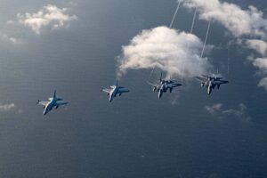 In this handout photo taken on November 21, 2023 received through the US embassy in Manila on November 23 shows two Philippine Air Force FA-50s (L) flying alongside two US Air Force F-15C Eagles over the South China Sea during the joint maritime and air patrols. US and Philippine troops began joint maritime and air patrols off the Southeast Asian country on November 21, President Ferdinand Marcos said, as the countries seek to counter China's growing assertiveness in the region. Airman 1st Class Alexis Redin / US AIR FORCE / AFP