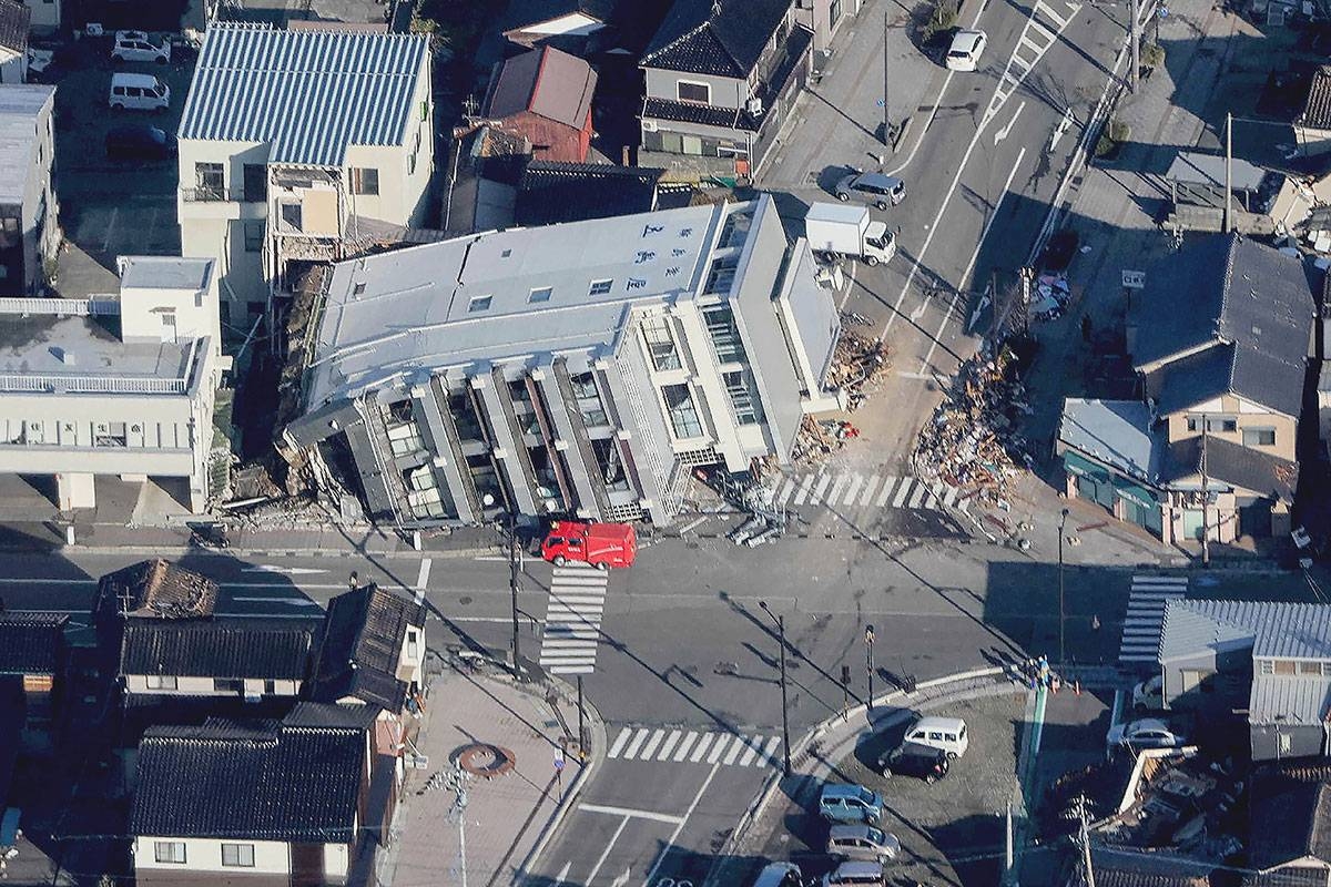TOPPLED This aerial photo provided by Jiji Press shows a rescue vehicle parked next to a seven-story building that fell over in Wajima, Ishikawa prefecture, on Tuesday, Jan. 2, 2024, a day after a major 7.5 magnitude earthquake struck the Noto region in Ishikawa prefecture. AFP PHOTO