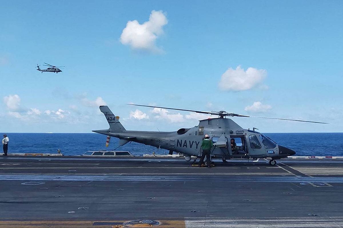 This handout photo from the Armed Forces of the Philippines taken on January 4, 2024 shows a pilot executing a final check in a Philippine Navy AW109 helicopter on the deck of the USS Carl Vinson during the second iteration of the Armed Forces of the Philippines and the US Indo-Pacific Command Military Cooperative Activity in the South China Sea. China on January 4 slammed what it called "provocative" moves by the United States and its ally the Philippines in the South China Sea, as both sides held drills in the disputed waters. Handout / ARMED FORCES OF THE PHILIPPINES / AFP