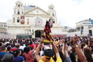 LIFTING IT UP A devotee raises a replica of the Black Nazarene during a first Friday mass in Quiapo, Manila, on Friday, Jan. 5, 2024. The Feast of the Black Nazarene is on Tuesday, January 9, and is expected to draw millions into a procession of the image around Manila, which is believed to be miraculous. The annual religious event is considered one of the biggest in the Philippines, where 80 percent of the population are Catholics. PHOTO BY RENE H. DILAN