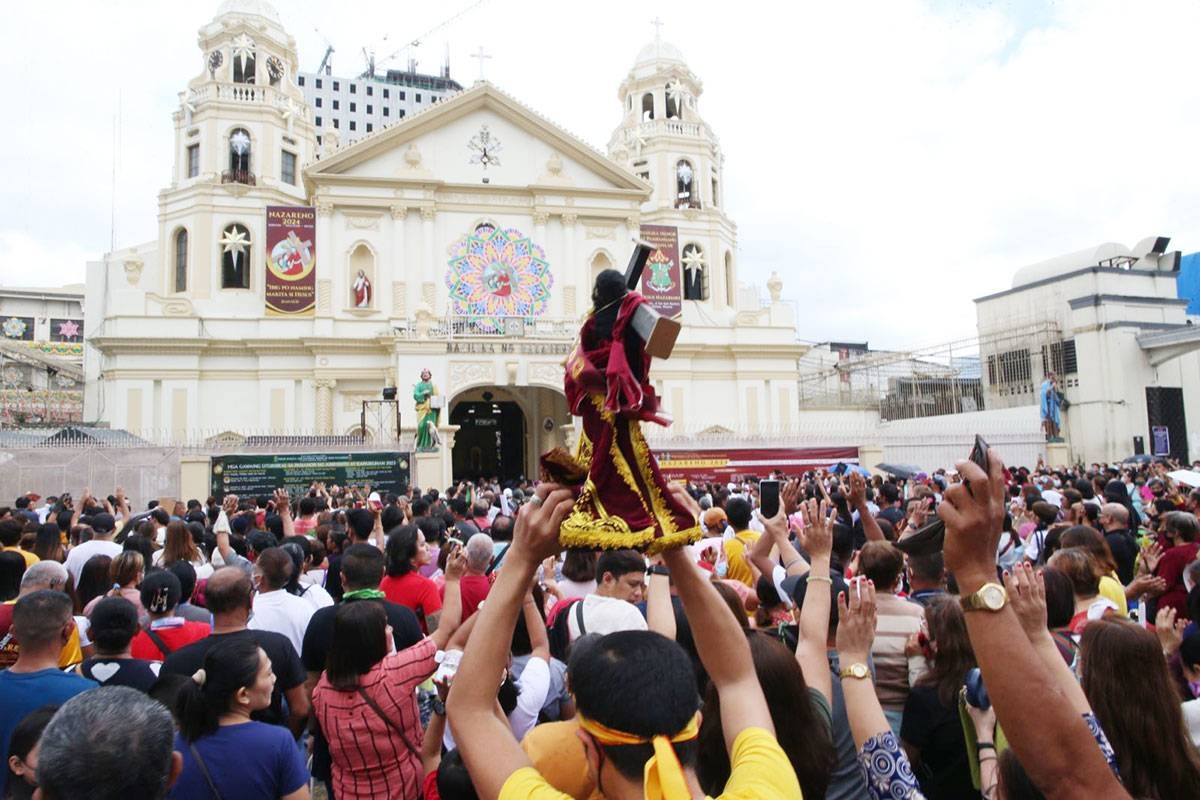 LIFTING IT UP A devotee raises a replica of the Black Nazarene during a first Friday mass in Quiapo, Manila, on Friday, Jan. 5, 2024. The Feast of the Black Nazarene is on Tuesday, January 9, and is expected to draw millions into a procession of the image around Manila, which is believed to be miraculous. The annual religious event is considered one of the biggest in the Philippines, where 80 percent of the population are Catholics. PHOTO BY RENE H. DILAN
