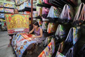 A customer chooses a calendar design at a printing shop along Commonwealth Avenue in Quezon City on Wednesday, Dec. 27, 2023. PHOTO BY MIKE DE JUAN