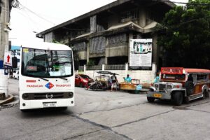 A modern public utility vehicle (MPUV) and traditional passenger jeep (PUJ) are seen waiting for passengers at the corner of Leon Guinto Street in Manila. PHOTO:MIKE ALQUINTO