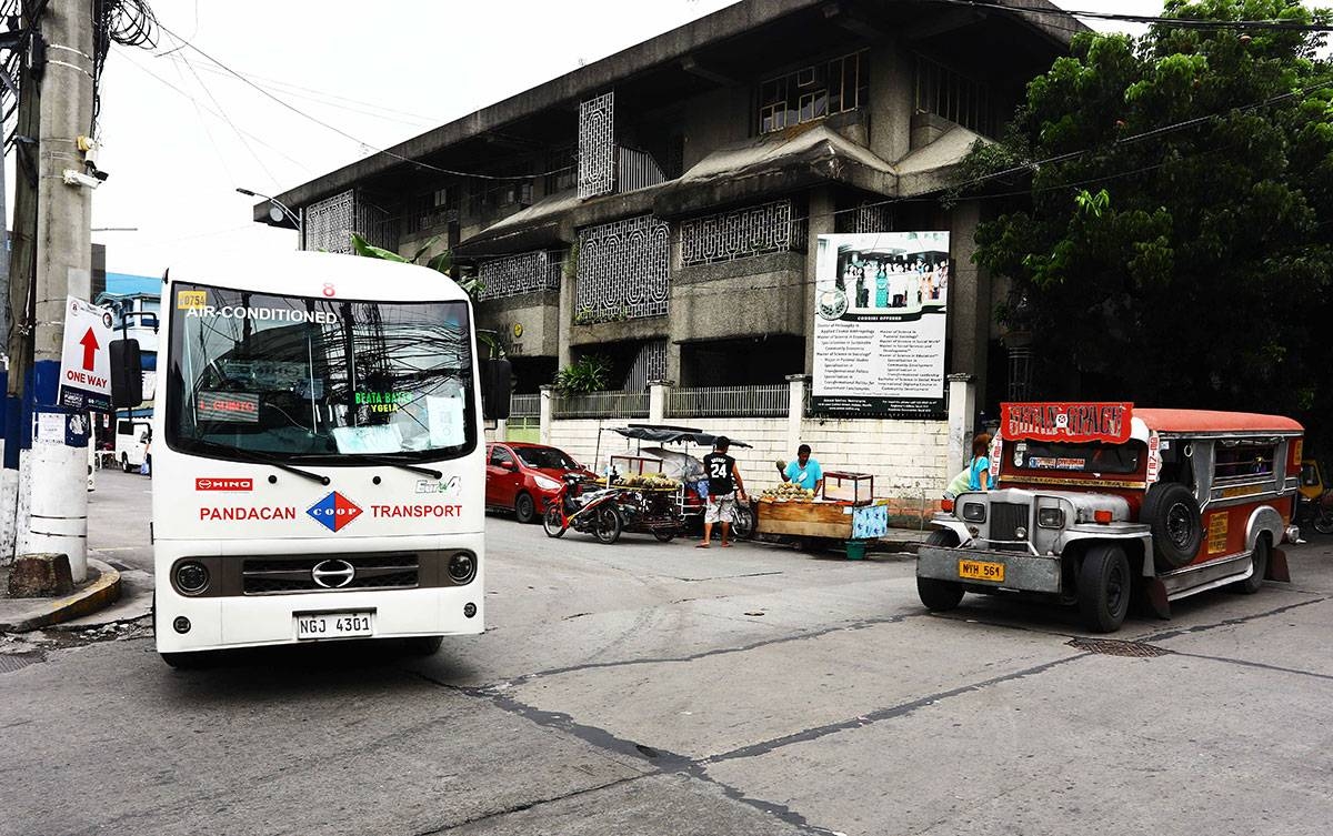 A modern public utility vehicle (MPUV) and traditional passenger jeep (PUJ) are seen waiting for passengers at the corner of Leon Guinto Street in Manila. PHOTO:MIKE ALQUINTO