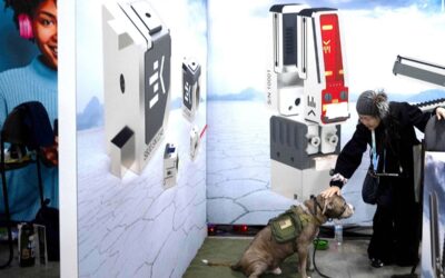 A woman pets a dog staying with her in a booth at the Eureka Park exhibition in the Venetian Expo Center during the Consumer Electronics Show on Tuesday, Jan. 9, 2024, in Las Vegas, Nevada. AFP PHOTO