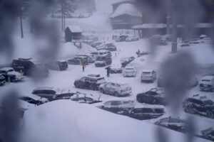 People through the parking area of the Alpine Base Area at Palisades Tahoe during a winter storm Friday, Feb. 24, 2023, in Alpine Meadows, California. AP PHOTO