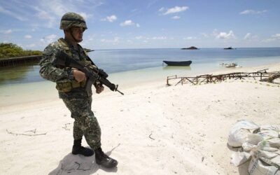 This photo shows a Philippine soldier Tychico Octobre patrols a beach in Pagasa Island (Thitu Island) at the Spratly group of islands in the South China Sea, west of Palawan, on May 11, 2015. AFP PHOTO / POOL / RITCHIE B. TONGO
