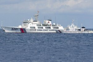 This photo taken on April 23, 2023 shows BRP Malapascua (right) maneuvering as a Chinese coast guard ship cuts its path at Second Thomas Shoal in the Spratly Islands. AFP PHOTO