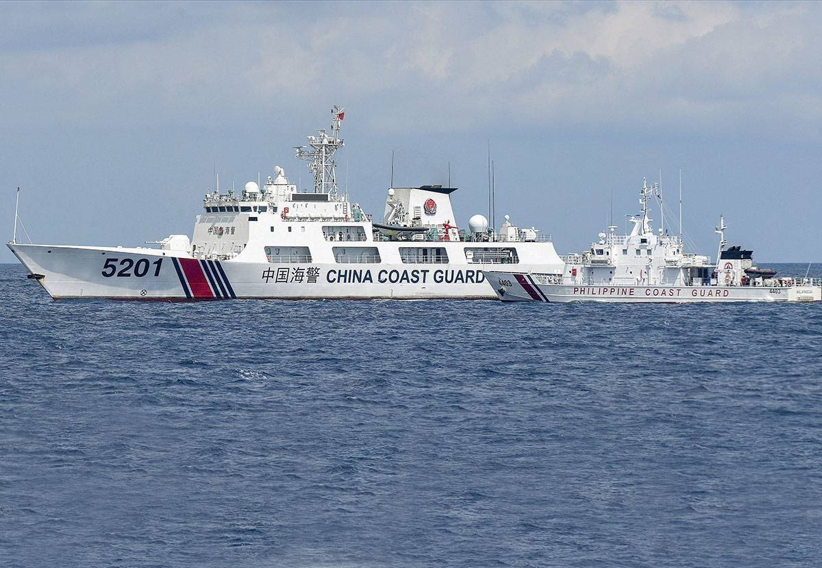 This photo taken on April 23, 2023 shows BRP Malapascua (right) maneuvering as a Chinese coast guard ship cuts its path at Second Thomas Shoal in the Spratly Islands. AFP PHOTO