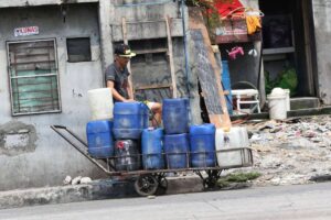 Children help fill up water containers in Tondo, Manila on Tuesday, April 11, 2023. Water shortage in parts of Metro Manila is expected at the onset of the dry season. PHOTO BY RENE H. DILAN