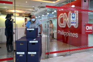 People walk past the CNN Philippines office in Mandaluyong, Metro Manila on January 29, 2024. The CNN Philippines officially announced that it will stop news production operations effective on January 31, as a result of “serious financial losses”. JAM STA ROSA / AFP