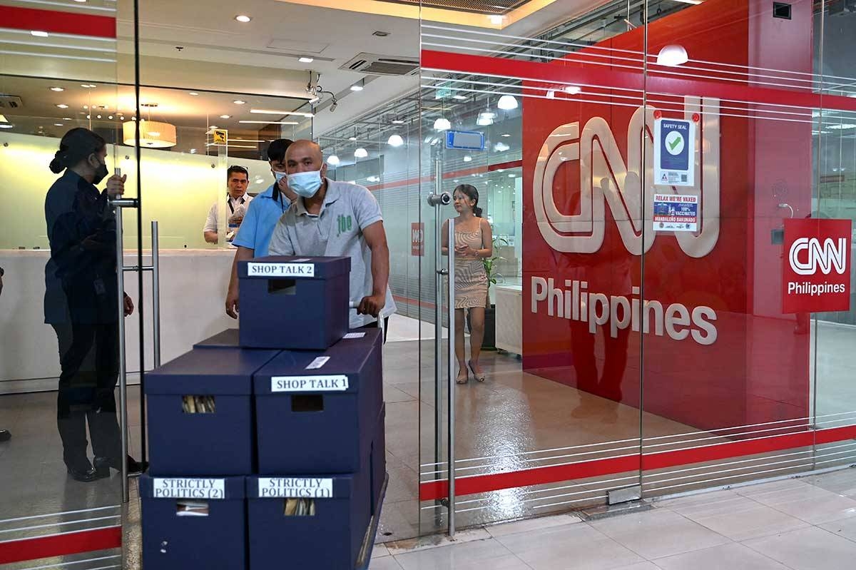 People walk past the CNN Philippines office in Mandaluyong, Metro Manila on January 29, 2024. The CNN Philippines officially announced that it will stop news production operations effective on January 31, as a result of “serious financial losses”. JAM STA ROSA / AFP