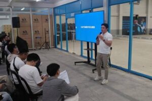 READY FOR 2024 Angkas co-founder and chief executive officer George Royeca (right) speaks at a ‘2024 and Beyond’ townhall on Jan. 24, 2024, at their headquarters in Makati City. CONTRIBUTED PHOTO