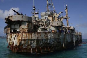 FILE - A dilapidated Philippine Navy ship LT 57 (Sierra Madre) with Philippine troops deployed on board is anchored off Second Thomas Shoal, locally known as Ayungin Shoal, on March 30, 2014, in the South China Sea. Chinese coast guard ships blocked and used water cannons on two Philippine supply boats heading to a disputed shoal occupied by Filipino marines in the South China Sea, provoking an angry protest against China and a warning from the Philippine government that its vessels are covered under a mutual defense treaty with the U.S., Manila's top diplomat said Thursday, Nov. 18, 2021. (AP Photo/Bullit Marquez, File)
