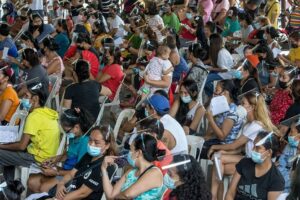 Residents of Barangay Pasong Tamo in Quezon City are herded at a covered court during the Department of Social Welfare and Development 4Ps’ — Pantawid Pamilyang Pilipino Program — verification of application for conditional cash grants to indigents on June 18, 2021. This is part of the government’s program to help the poorer population improve the health, nutrition and education of their children aged 0 to 18. The crowd, however, seemed to have forgotten about the pandemic as they failed to observe the health protocol on physical distancing to avoid Covid-19 infection. PHOTO BY RUY L. MARTINEZ