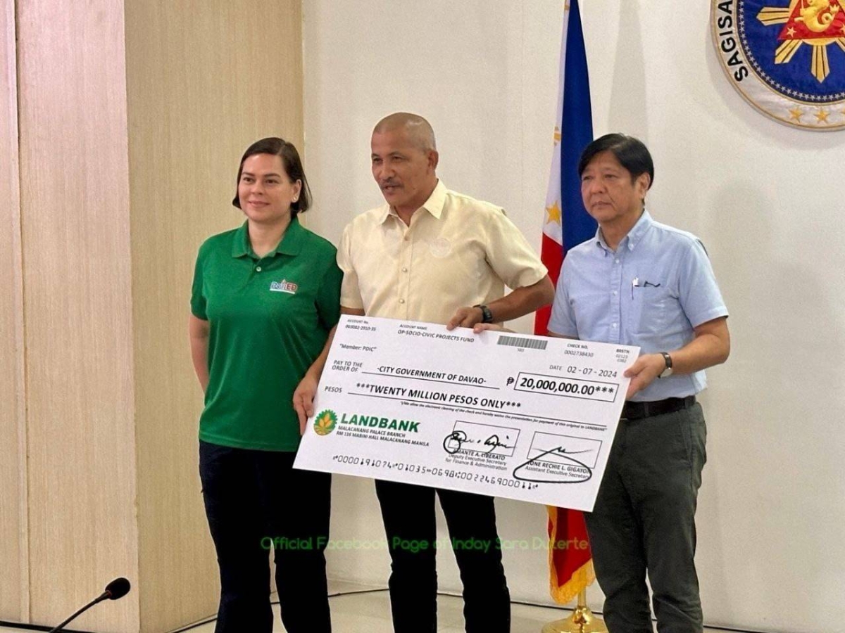GOVT AID A representative from Davao City receives the P20 million cash assistance from President Ferdinand Marcos Jr. (right) and Vice President Sara Duterte in Davao on Thursday, Feb. 8, 2024 for residents affected by the floods and landslides. PHOTO FROM OVP COMMUNICATIONS