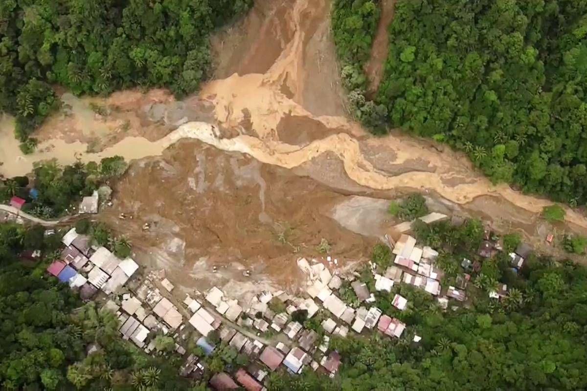 This screengrab from AFPTV aerial video footage taken on Wednesday, Feb. 7, 2024, shows the site of a landslide in Davao de Oro province on Mindanao island in the southern Philippines. At least five people were killed and 31 injured when a rain-induced landslide engulfed two buses and houses in a mountainous region of the southern Philippines, an official said. PHOTO BY RENANTE NAPARAN/AFP