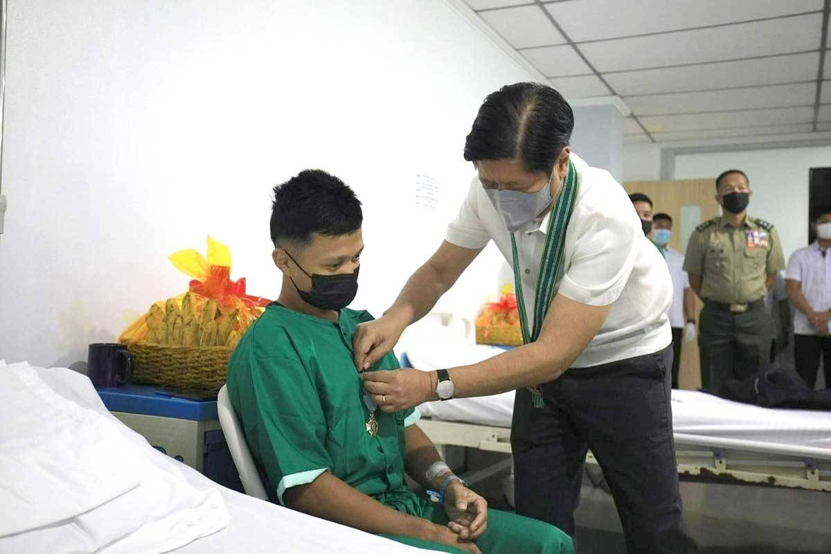 President Ferdinand Marcos Jr. awards the Gold Cross Medal to a combat-wounded soldier during his visit to the Army General Hospital in Fort Bonifacio, Taguig City, on Monday, Feb. 12, 2024. Contributed photo