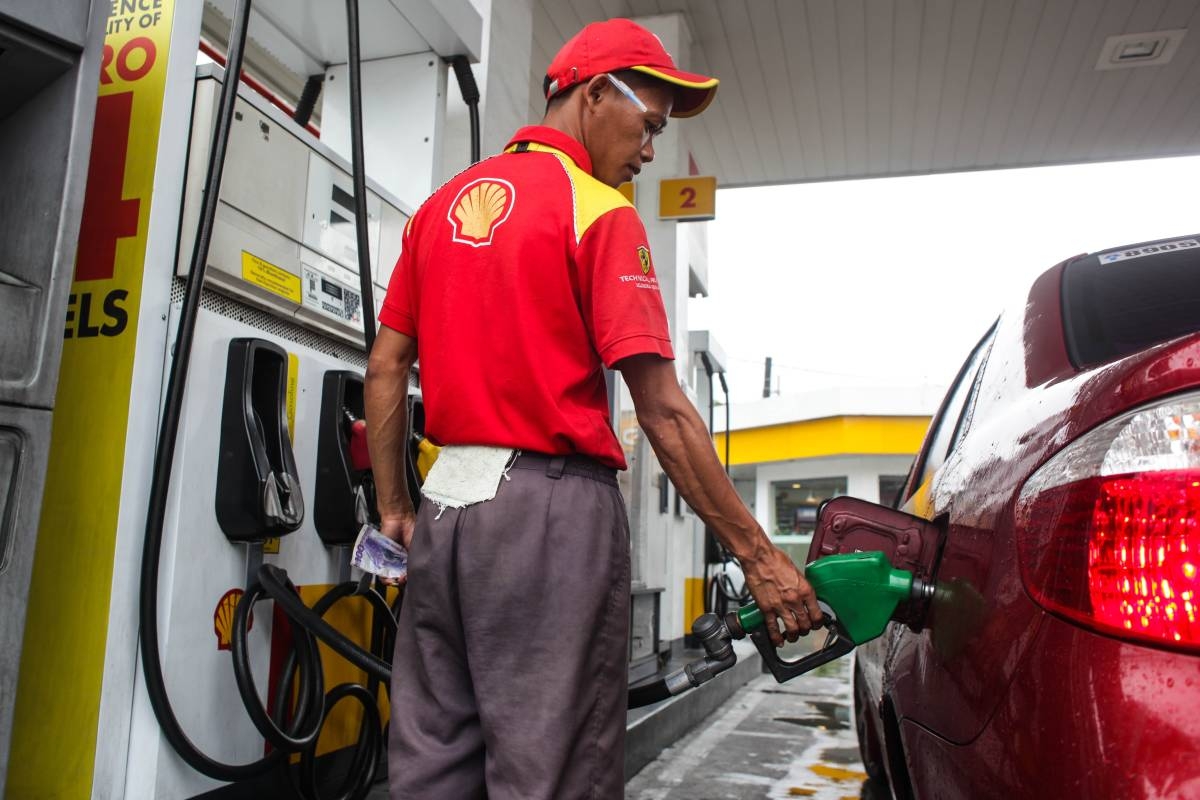 A Filipino man holds fuel pump to fill up the car at shell gas station along U.N Avenue in Manila. Photo by: Dj Diosina