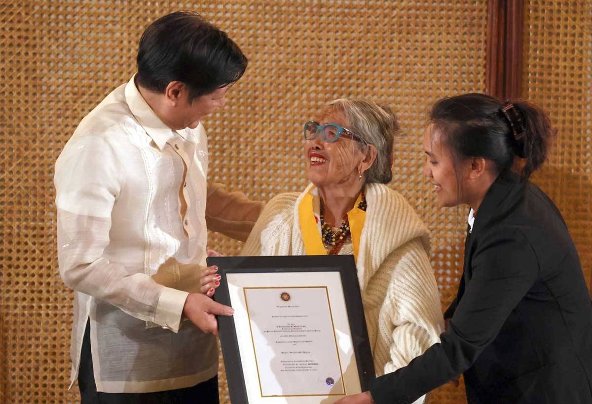 President Ferdinand R. Marcos Jr. awards the Presidential Merit Award to 106-years old traditional tattoo artist Apo Whang-Od during a ceremony at the Malacanang Palace on Wednesday, February 14, 2024. (KJ ROSALES/PPA POOL)