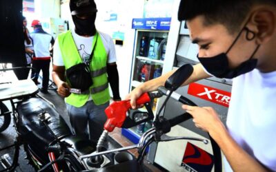 A guy filling up a motor tank