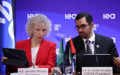 COP28 president Sultan Ahmed al-Jaber talks to State secretary and special envoy for intenational climate action German Jennifer Morgan (L) during a high-level round table on COP energy and climate commitments organised by the International Energy Agency (IEA) at its headquarters in Paris on February 20, 2024. The world needs 'trillions' of dollars to spur on the green transition and tackle global warming, the head of last year's COP28 climate talks said, warning that political momentum can evaporate without clear action. (Photo by ALAIN JOCARD / AFP)