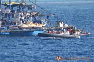 This handout photo taken on February 22, 2024 and received on February 25, 2024 from the Philippine Coast Guard shows China Coast Guard personnel onboard a rigid-hulled inflatable boat (right) as they shadow a Philippine fishing boat (left) during the Philippine Bureau of Fisheries and Aquatic Resources (BFAR) mission to bring supplies to fishermen near the China-controlled Scarborough Shoal in the disputed South China Sea. AFP PHOTO / Philippine Coast Guard