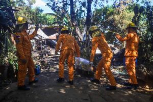 Firemen on Monday, February 26, search through debris as they investigate the cause of the fire at Alta Monte, Barangay Dolores in Taytay, Rizal. PHOTOS BY JOHN ORVEN VERDOTE