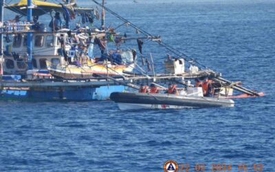 This handout photo taken on February 22, 2024 and received on February 25, 2024 from the Philippine Coast Guard shows China Coast Guard personnel onboard a rigid-hulled inflatable boat (R) as they shadow a Philippine fishing boat (L) during the Philippine Bureau of Fisheries and Aquatic Resources (BFAR) mission to bring supplies to fishermen near the China-controlled Scarborough Shoal in the disputed South China Sea. AFP PHOTO / Philippine Coast Guard