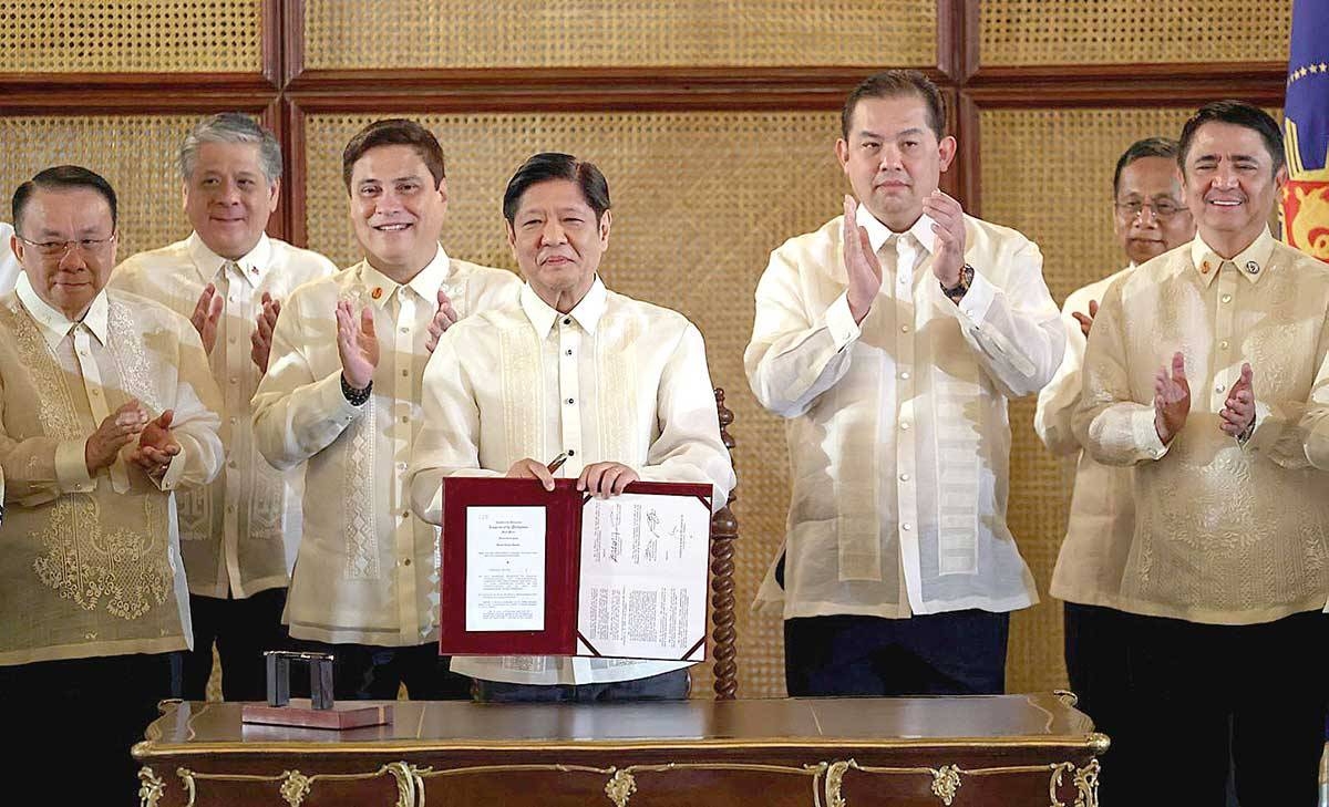 Signed President Ferdinand Marcos Jr. holds a copy of the Tatak Pinoy Act at the Ceremonial Hall in Malacañang on Monday, Feb. 26, 2024. PPA POOL PHOTO