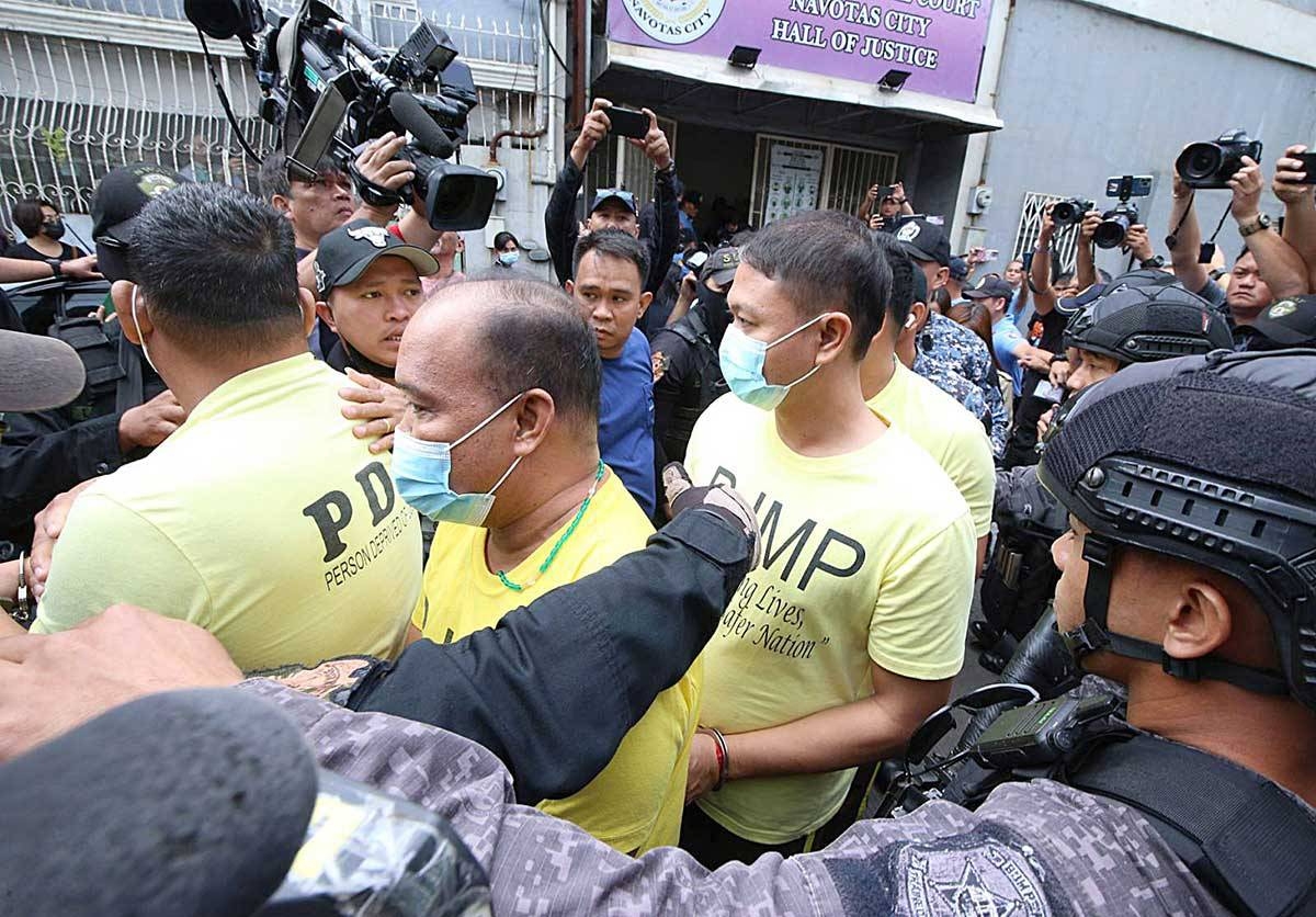 JUDGMENT DAY Policemen accused in the killing of Jemboy Garcia,17, are escorted outside the Navotas Regional Trial Court on Tuesday, Feb. 27, 2024. Only one policeman was convicted. PHOTO BY RENE H. DILAN