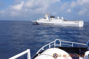 This handout photo taken on February 22, 2024 and received on February 25, 2024 from the Philippine Coast Guard shows a China Coast Guard vessel sailing near the BRP Datu Sanday during their mission to bring supplies to fishermen near the China-controlled Scarborough Shoal in the disputed South China Sea. AFP PHOTO / Philippine Coast Guard